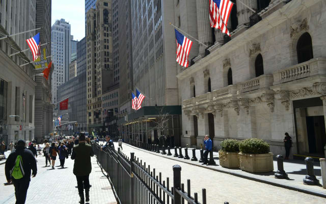 Wall Street in New York with American flags on the buildings