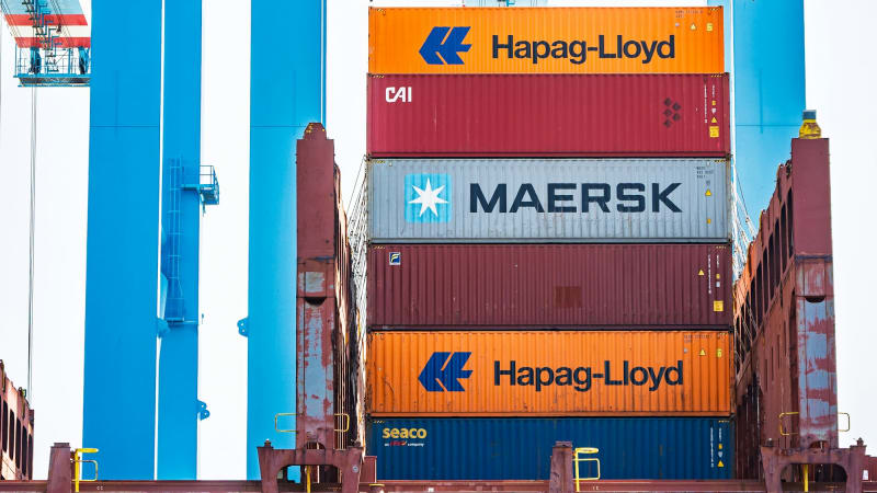Crane loading shipping containers onto a cargo ship at a port