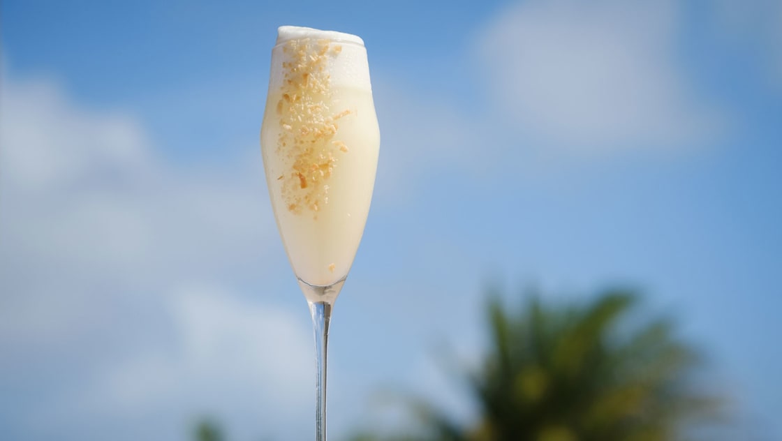 Ave's pina colada cocktail with blue sky background