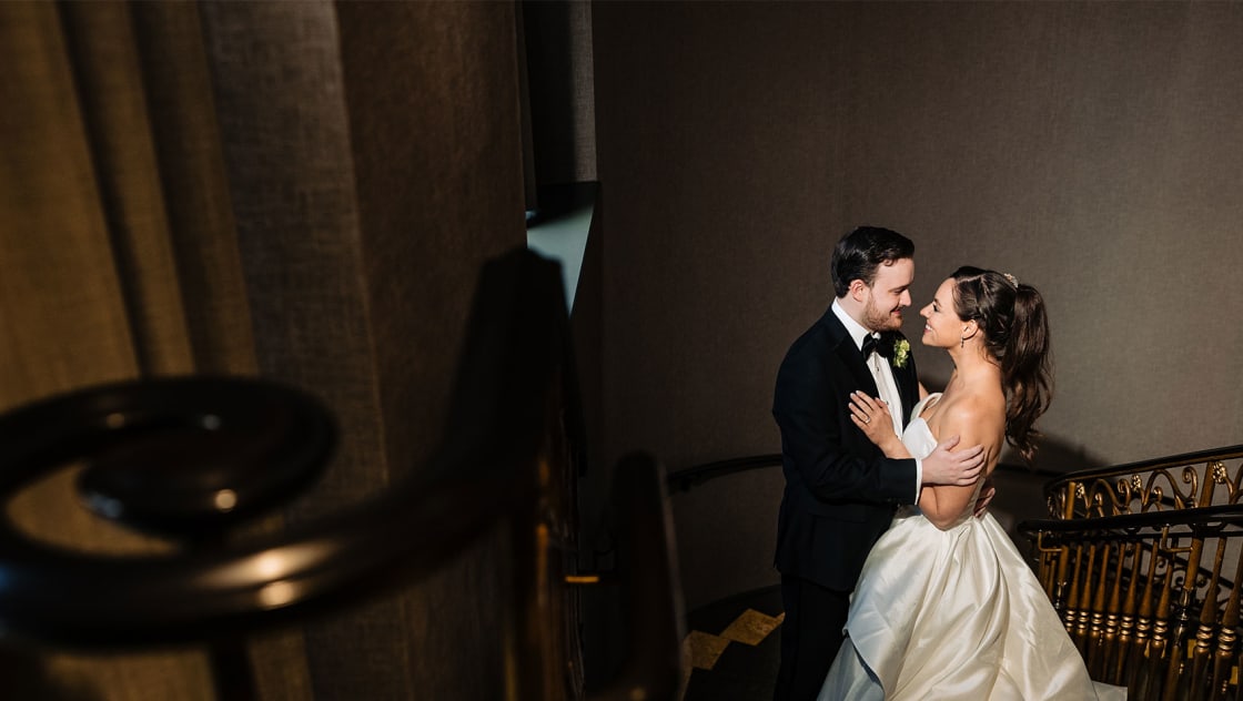 wedding couple on the grand staircase of kimpton marlowe