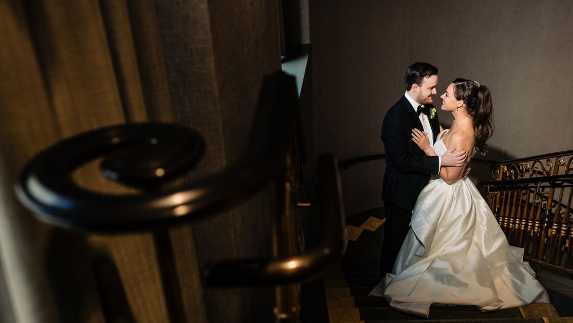 bride and groom embracing on stairs