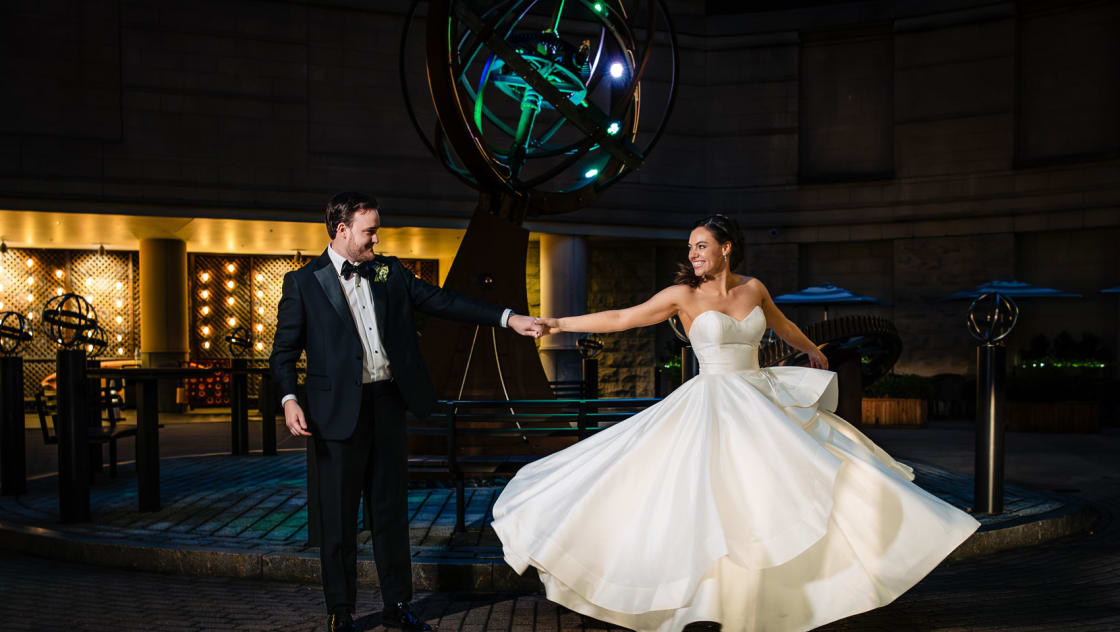 bride and groom dancing in front of kimpton marlowe