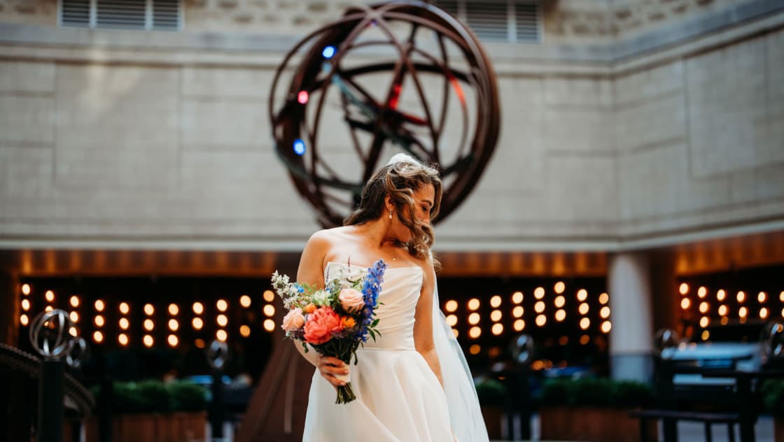 bride holding flowers in front of kimpton marlowe