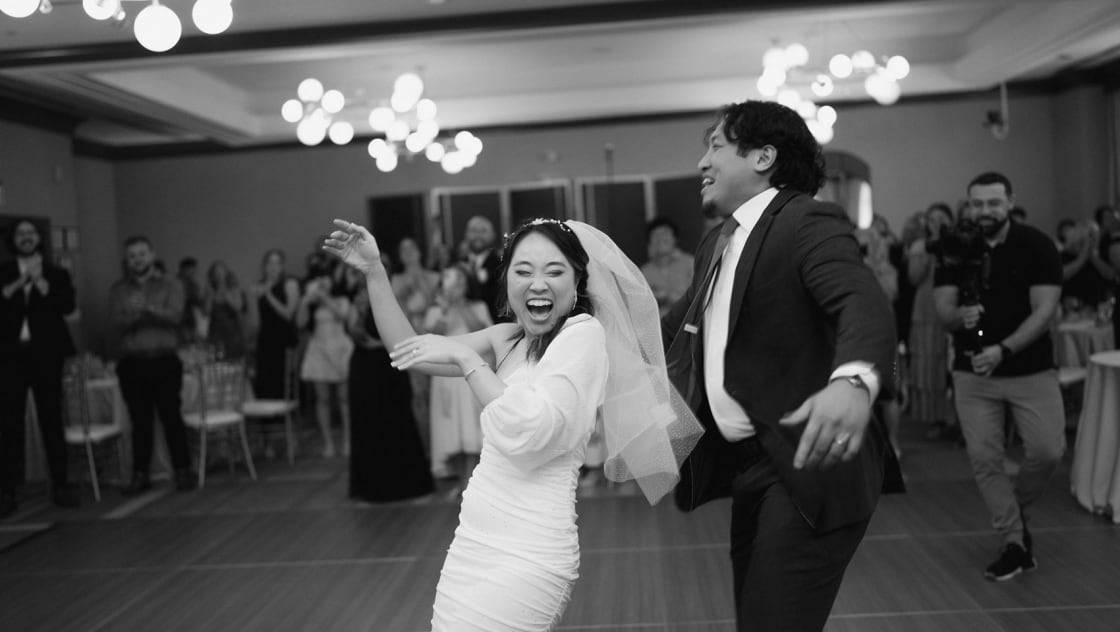 bride and groom on dancefloor laughing