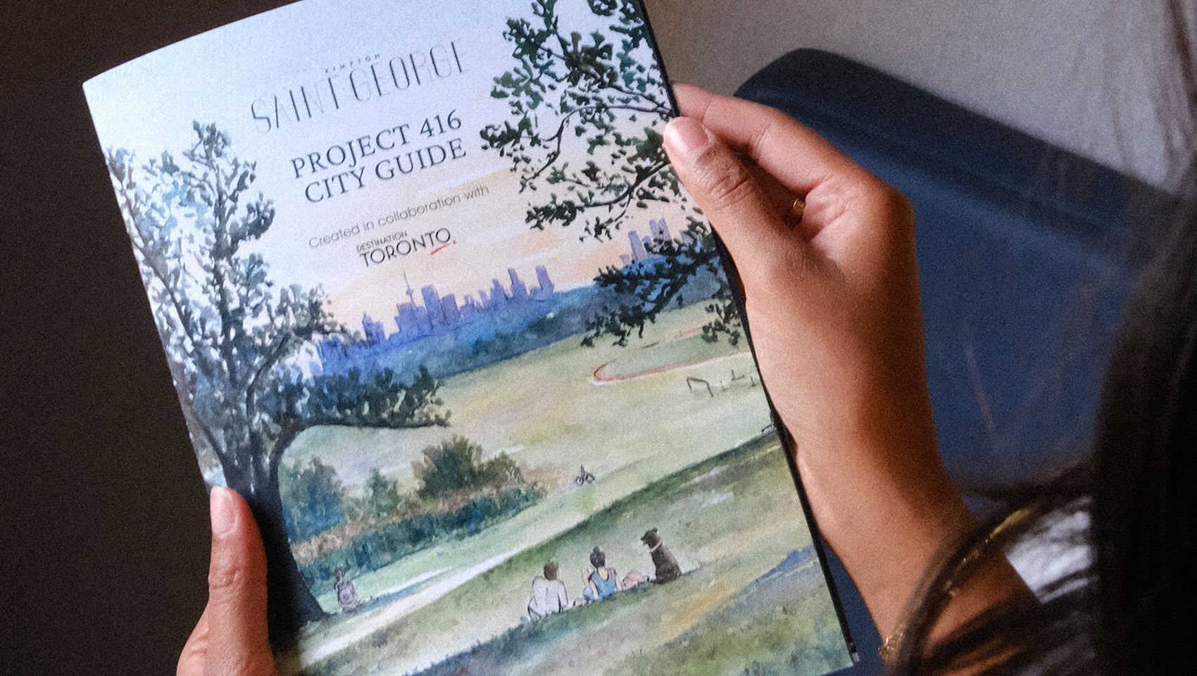 woman holding project 416 city guide