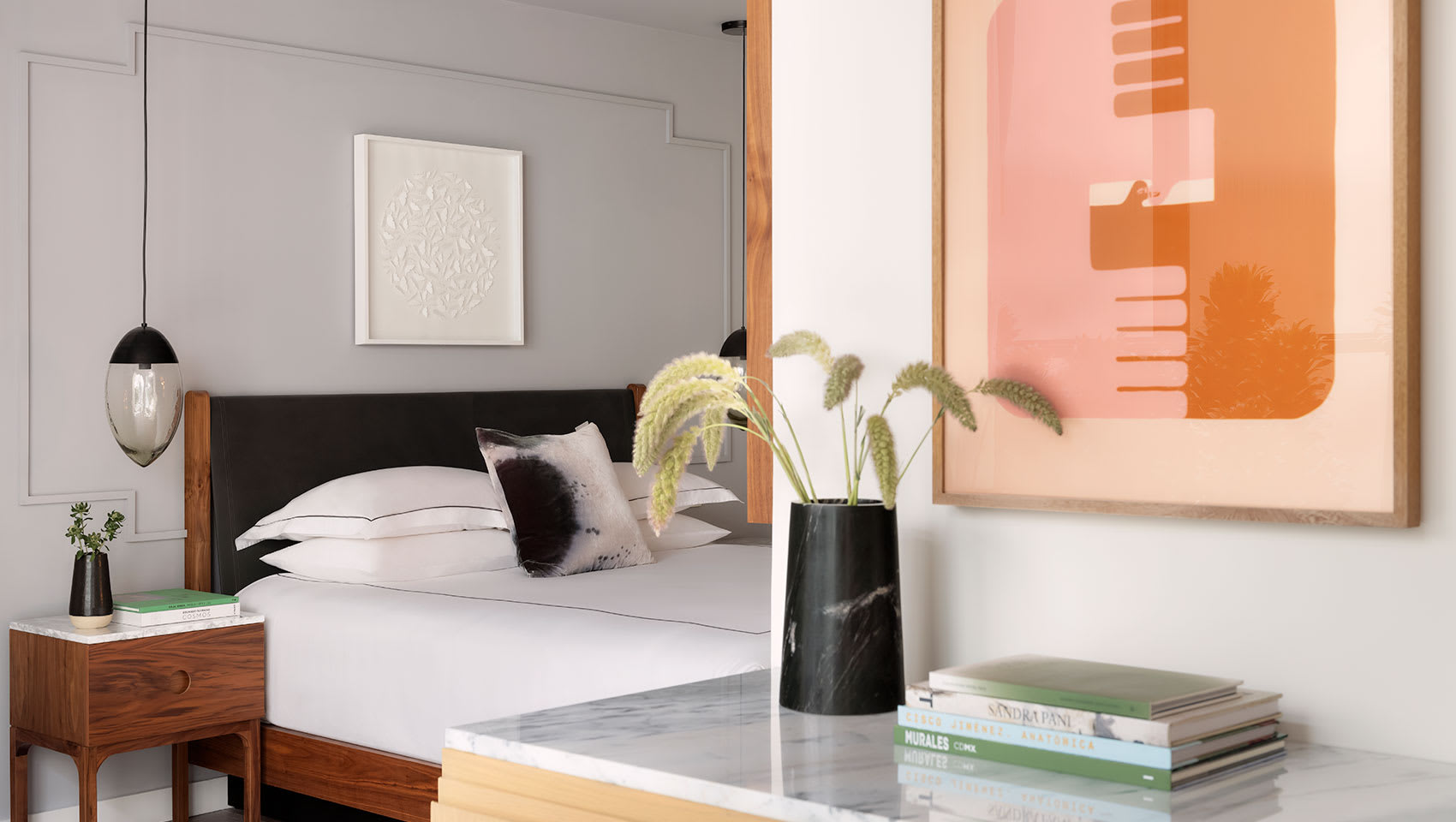 Table and bed in One Bedroom Spa Suite at Kimpton Virgilio Hotel