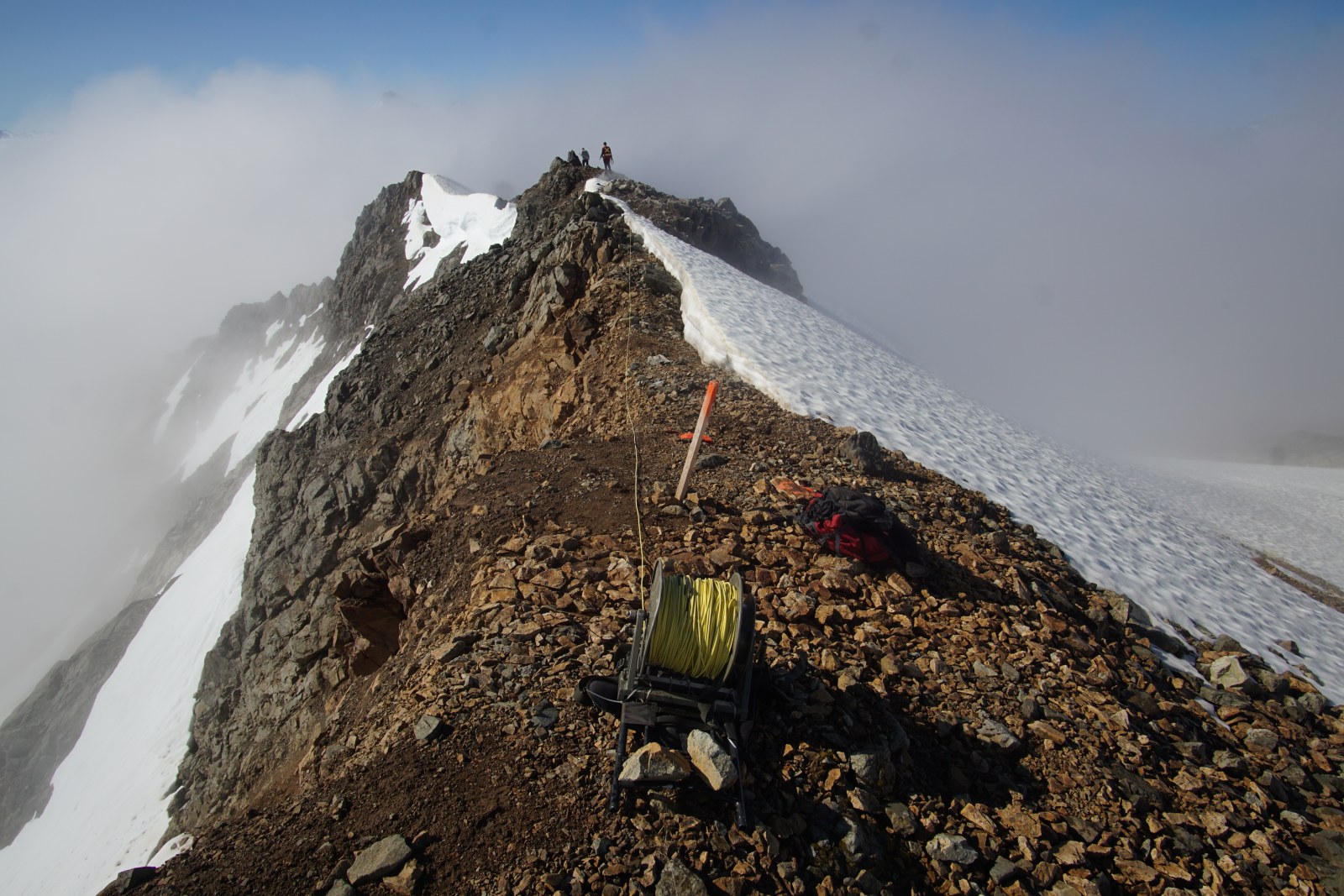 Field crew conducting an induced polarization (IP) survey on an alpine ridge in British Columbia