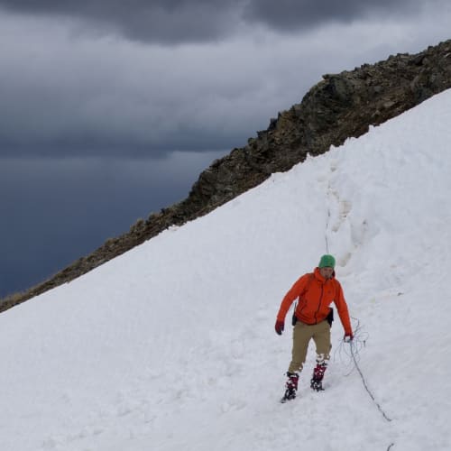 Walking an induced polarization survey line across steep snow at Sidina