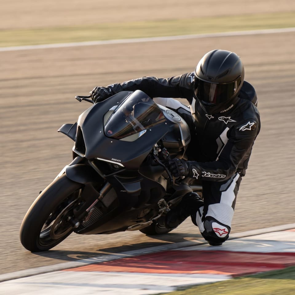 Mono Alpinestars Negro/Blanco: piloto en pista con el equipo puesto