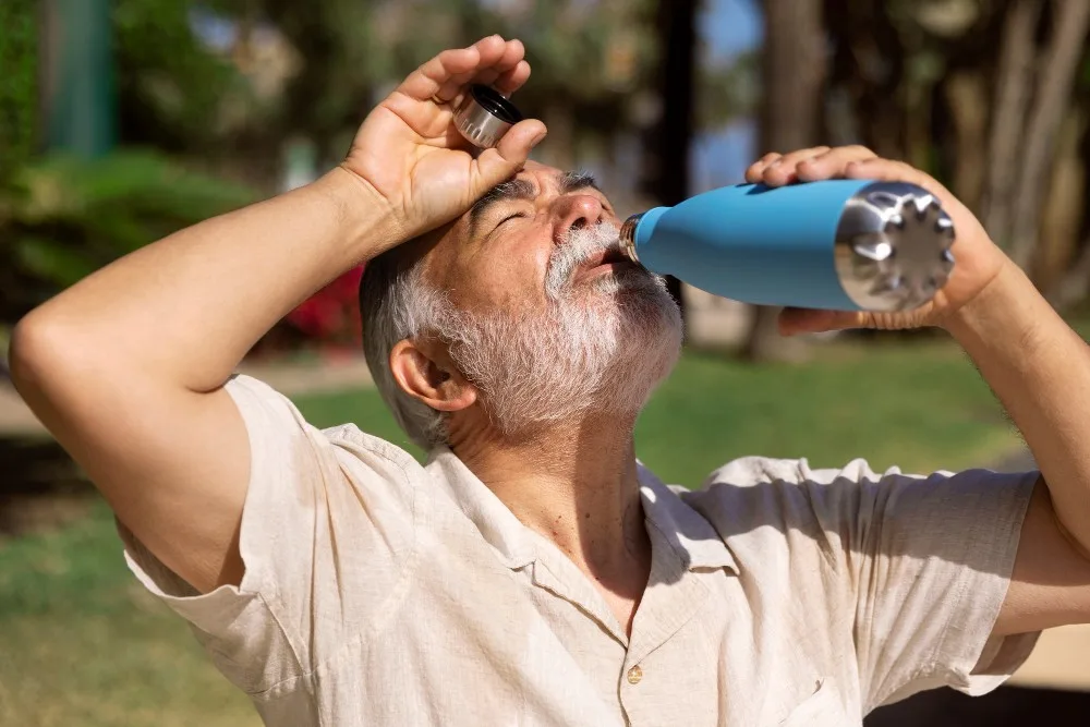 Heatstroke - Old Man Driking Water in Summer