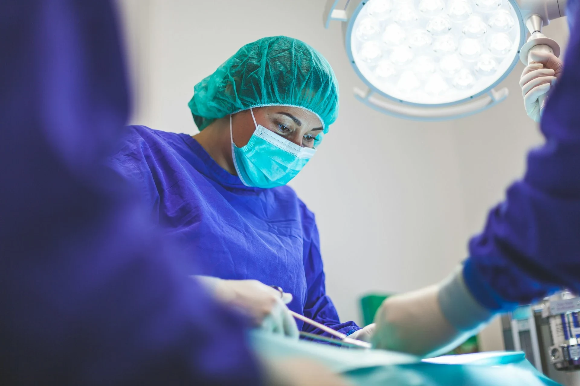 A professional Indian doctor examining a patient in a modern hospital