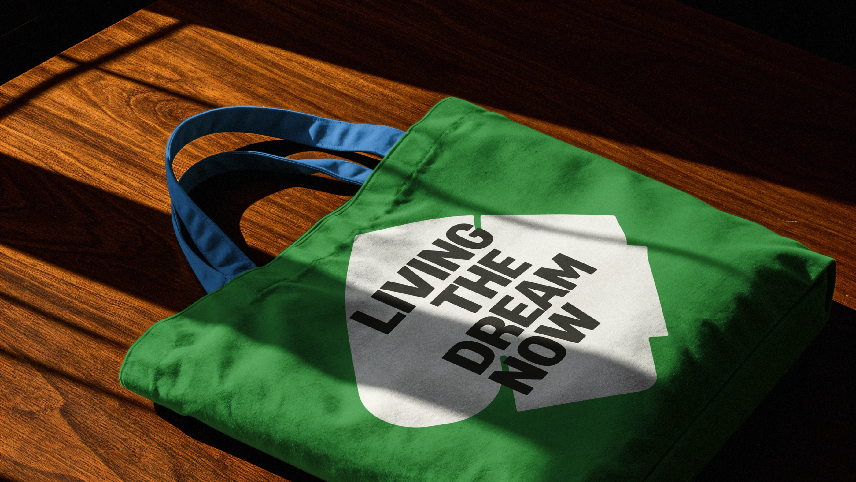Bold screen-printed graphic on a green canvas tote bag