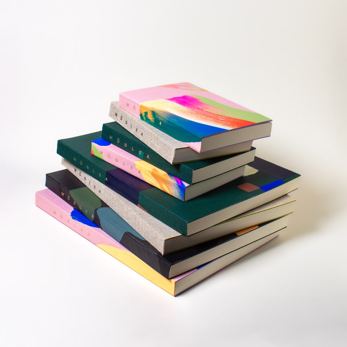 Stack of premium cloth-bound art journals with foil branding