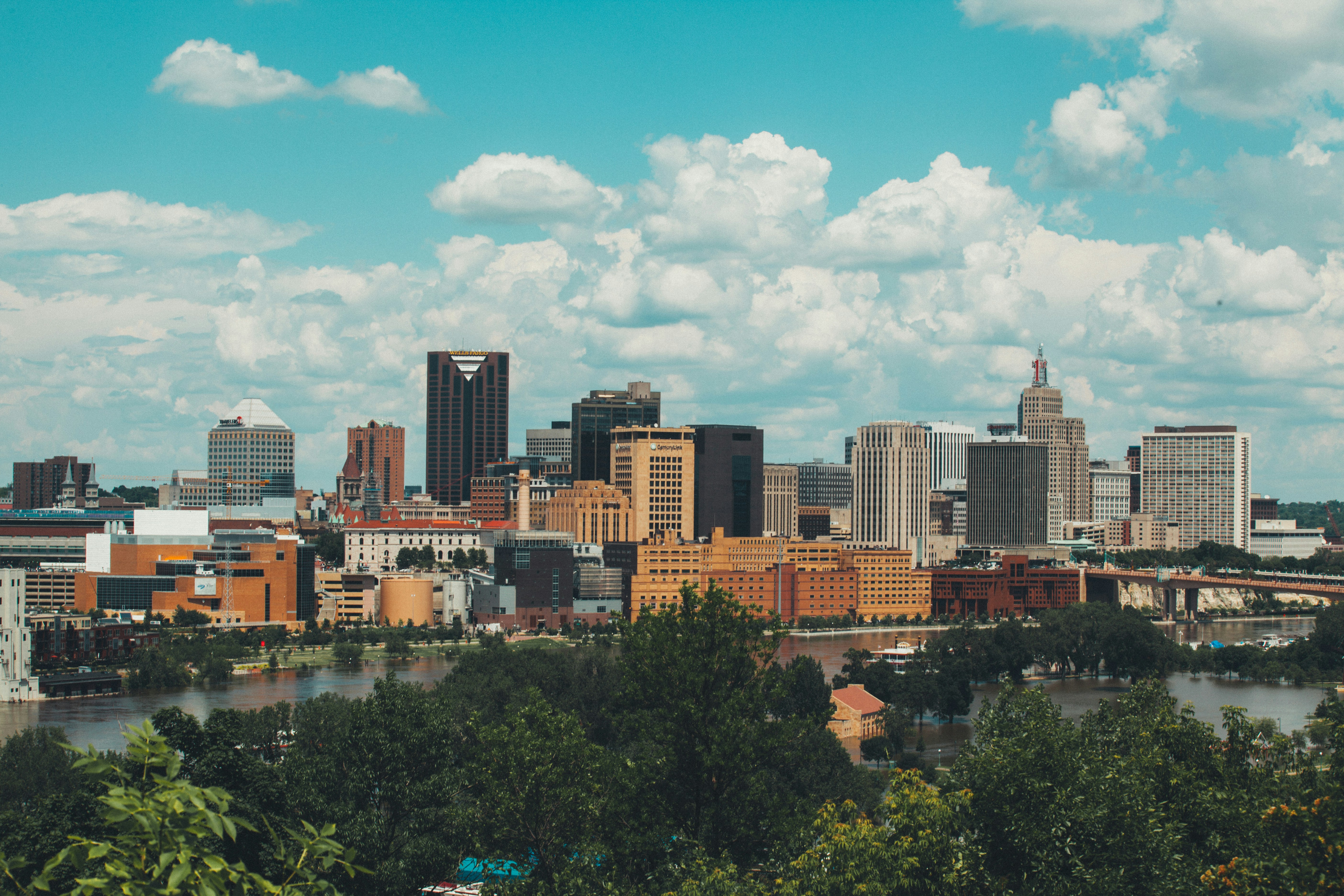 A landscape shot of a city past a river.