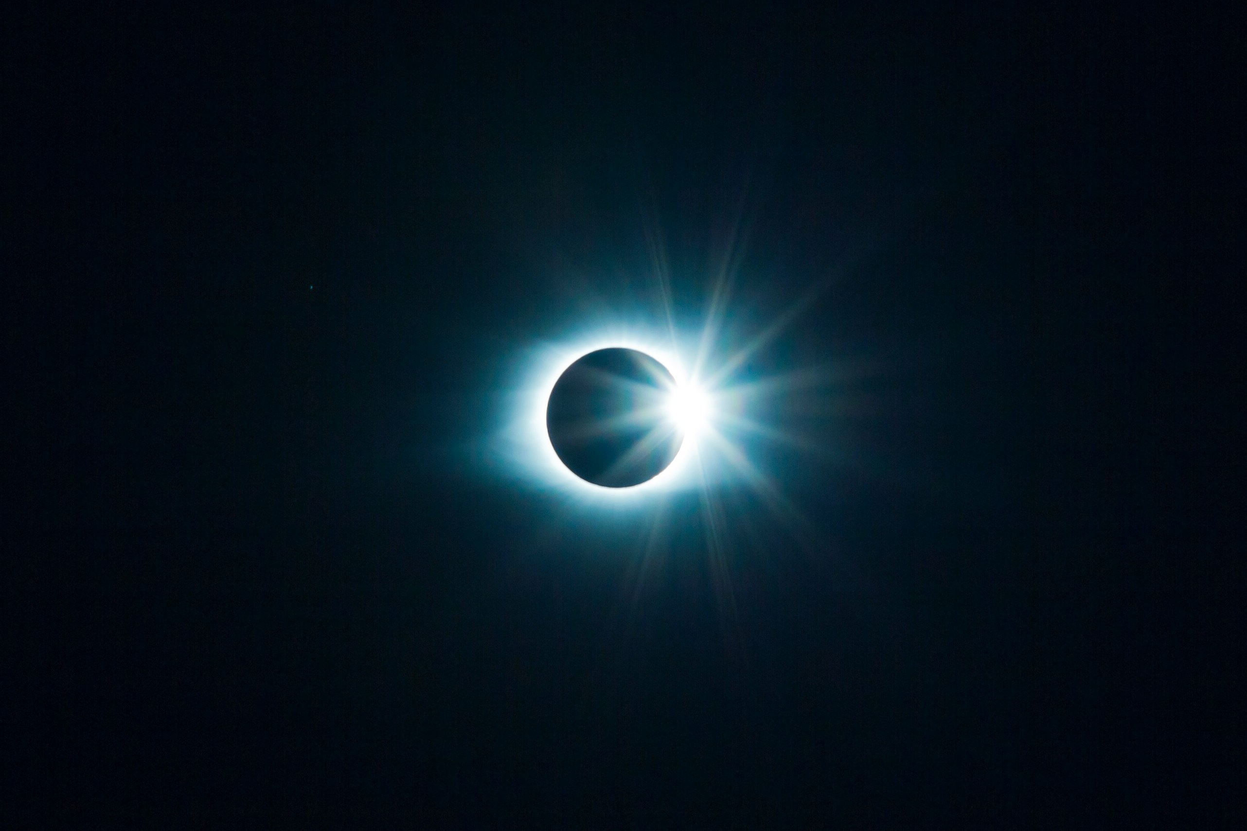 The sun being covered by the moon in an eclipse.
