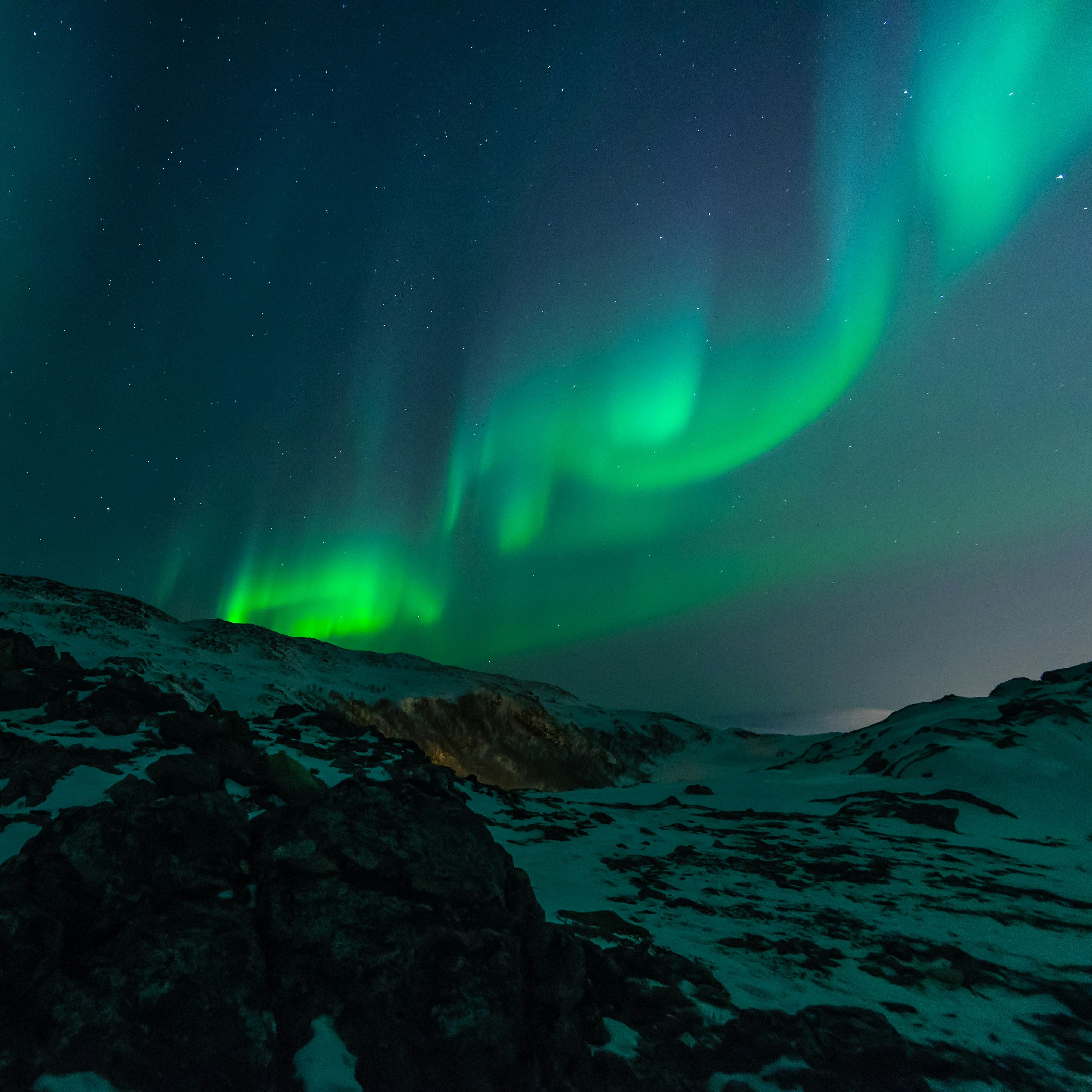 Aurora borealis over a mountain top.