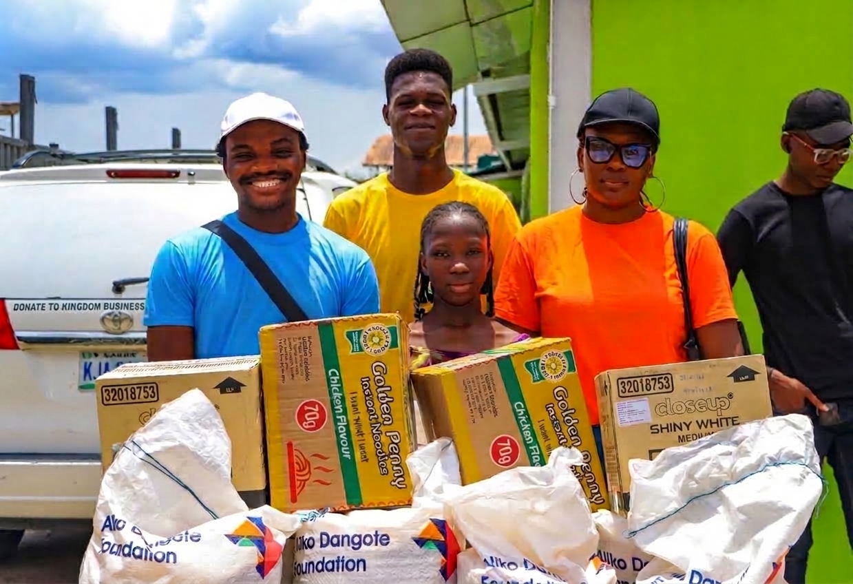 KBX members and volunteers distributing food supplies to a community