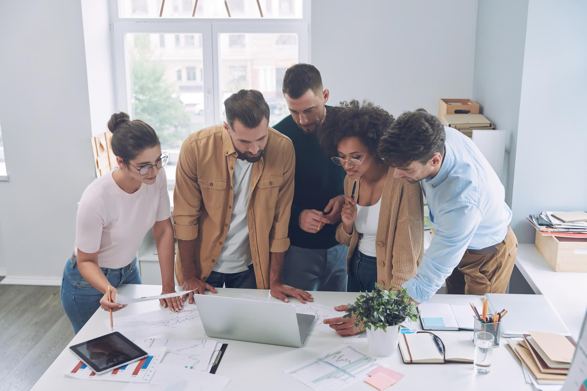 Great Careers, Greater Growth – Join Xinzex’s Future-Ready Team! Diverse Xinzex team collaborating in a modern tech workspace, smiling and discussing innovative projects