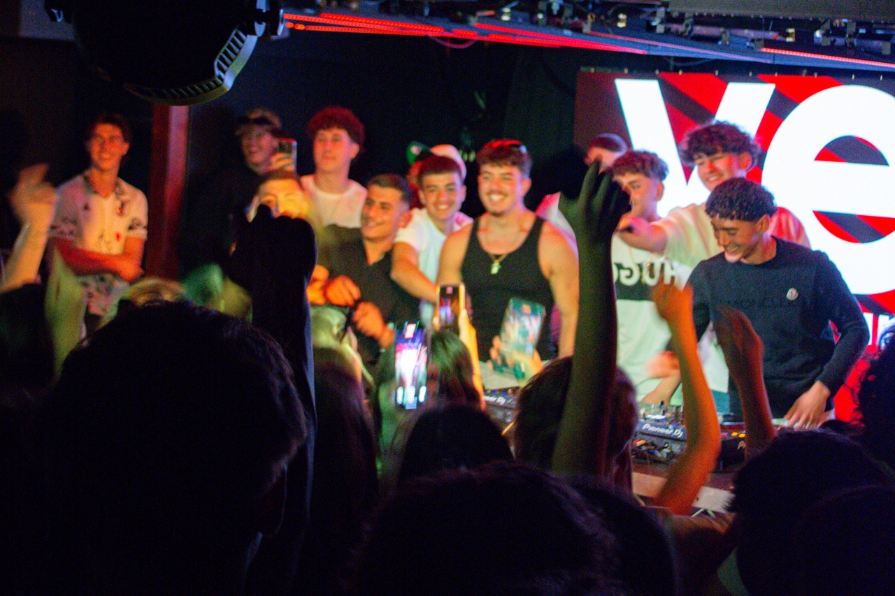 Boys around the DJ booth