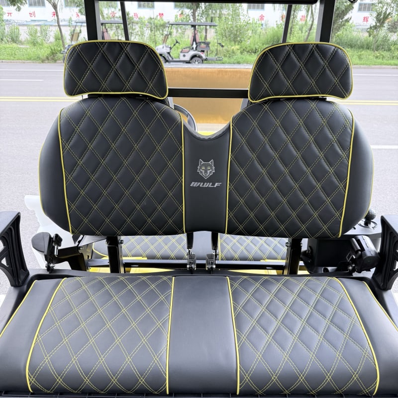 Close-up of the diamond-stitched seat backs with contrast piping and the Wulf badge