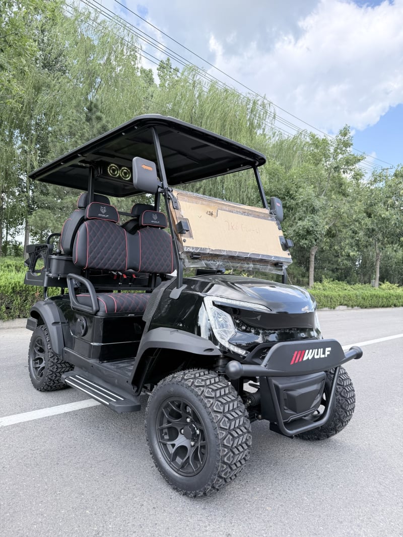 Black Wulf golf cart with red stitching, front three-quarter angle
