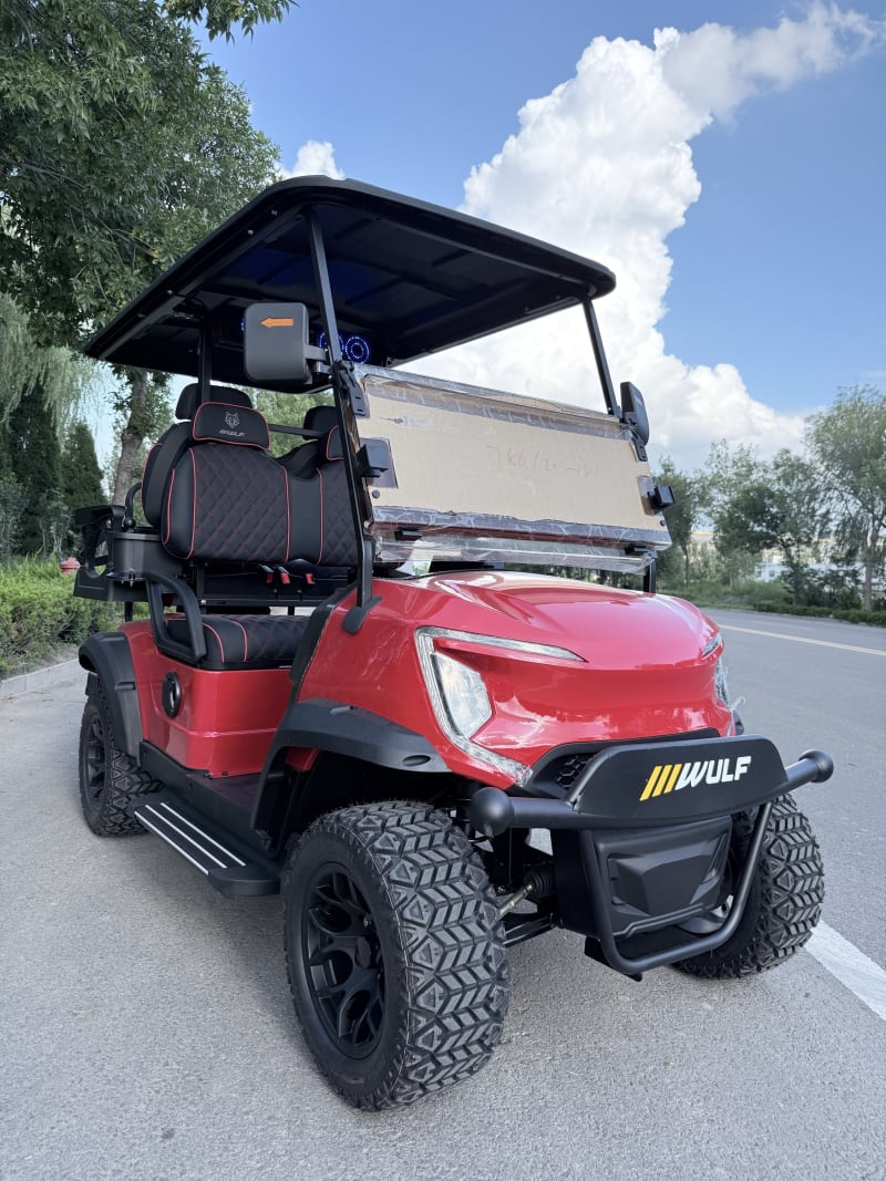 Red Wulf golf cart photographed from the front three-quarter angle