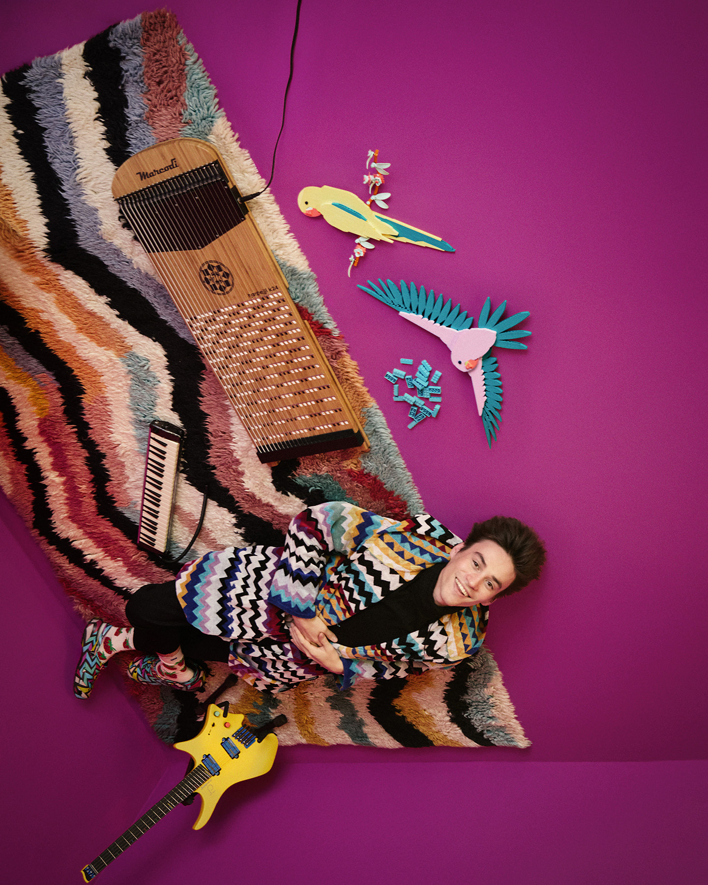 Overhead shot of Jacob Collier in flow state, surrounded by instruments and LEGO Birds of Paradise