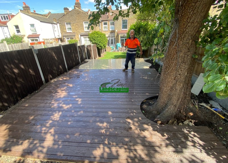 Dark decking fitted around a mature garden tree