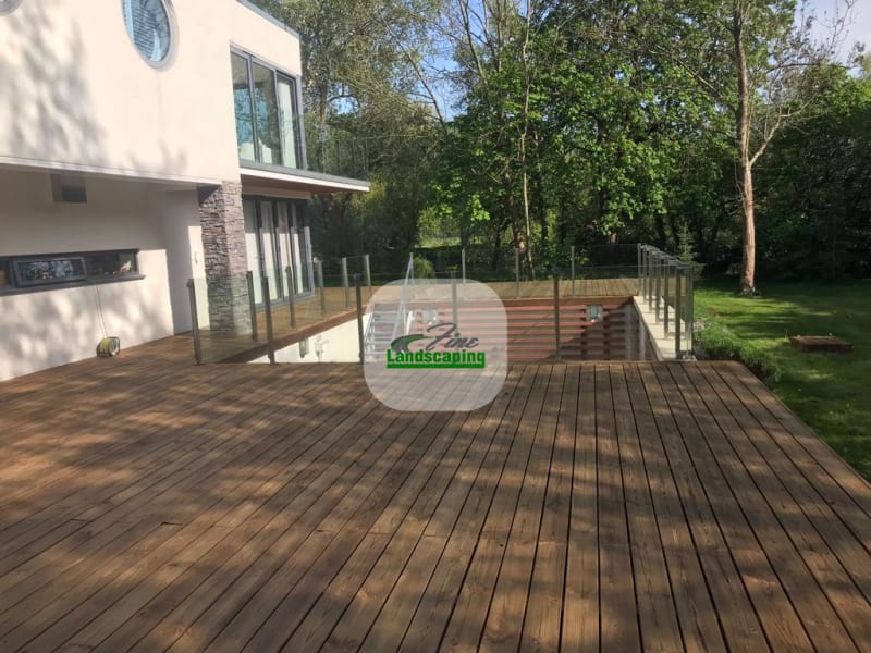 Timber deck extending from a house into a planted garden