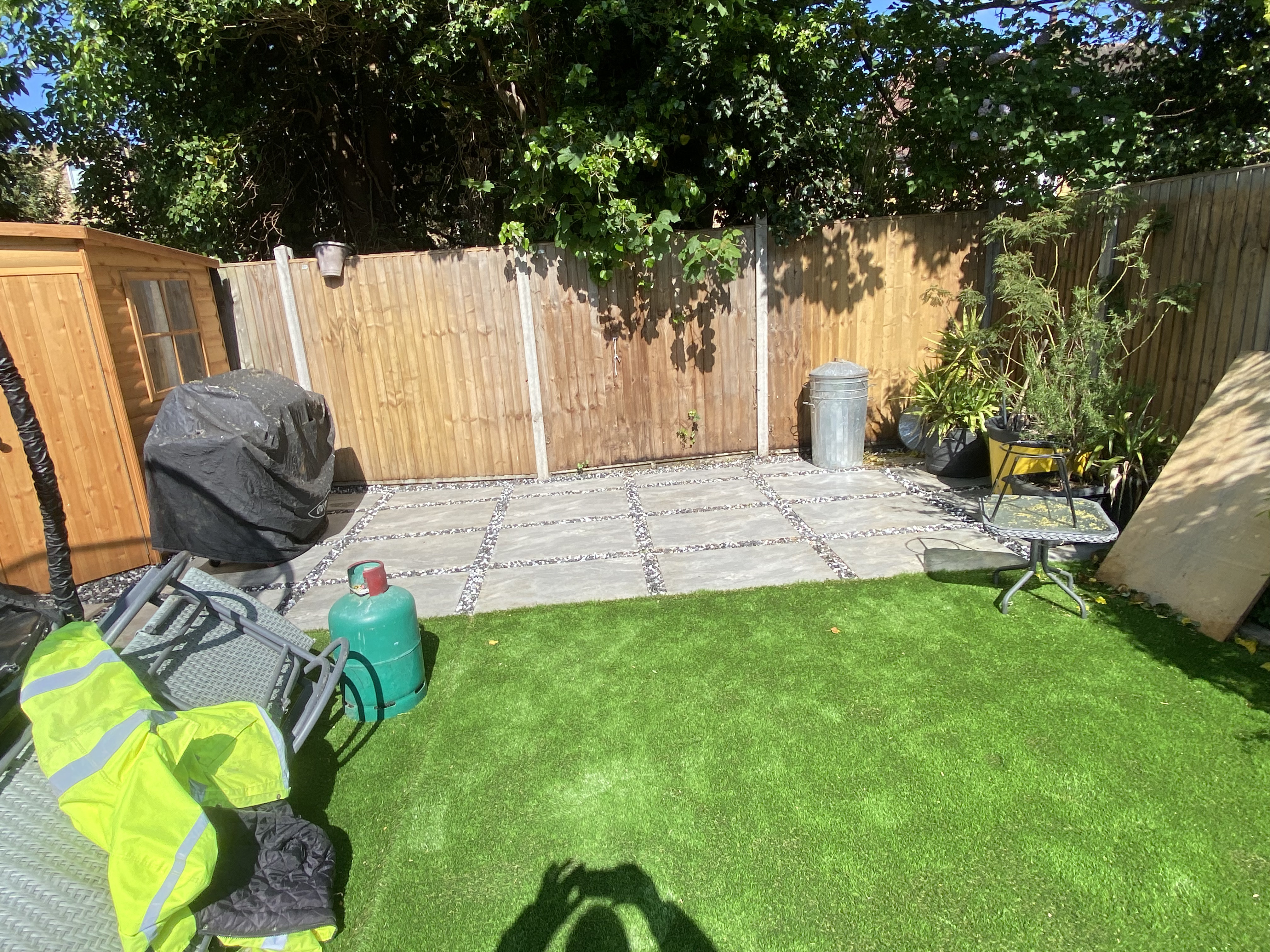 Completed back garden landscaping in Streatham SW16 with decking, astro grass, and gravel pathways