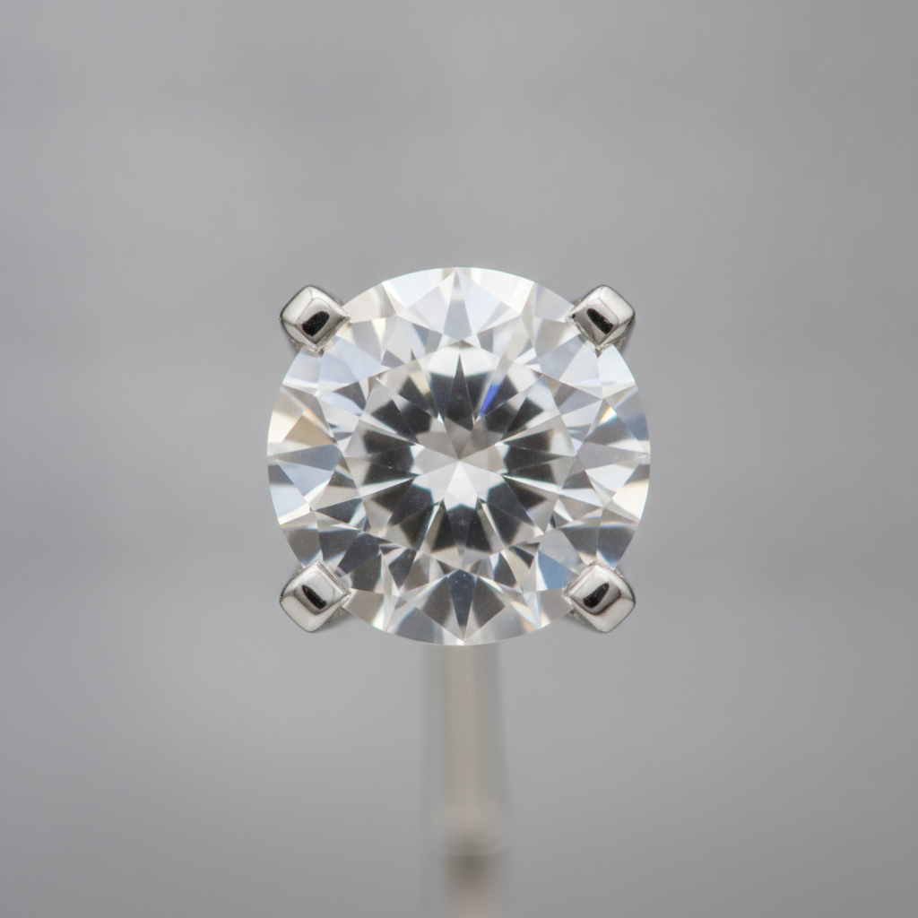 Close-up of a lab-grown diamond stud earring in white gold, showing brilliant cut facets and secure four-prong setting