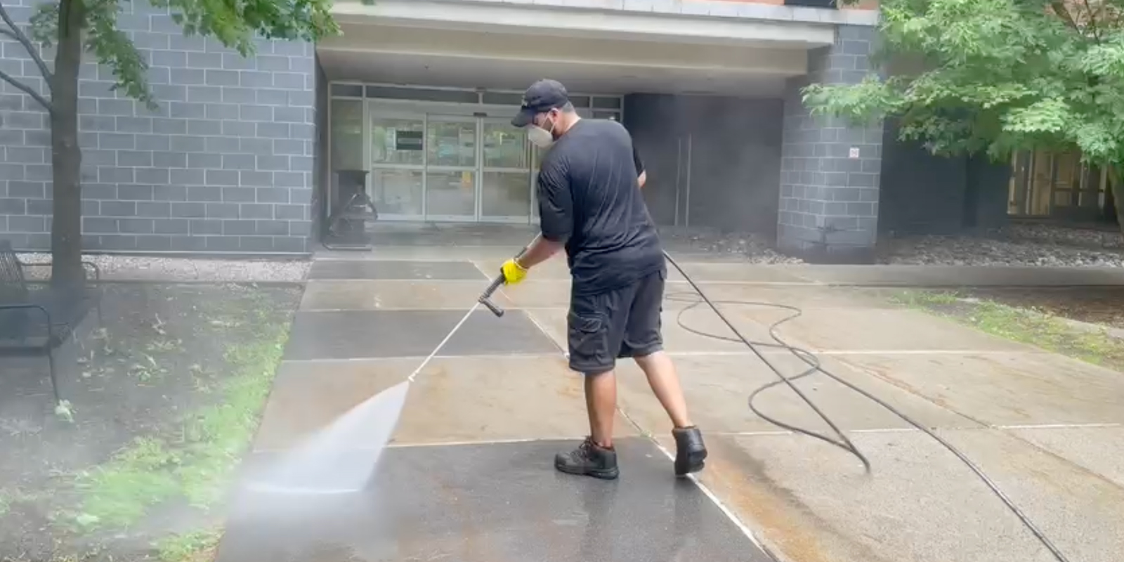 Professional commercial pressure washing team working efficiently while minimizing business disruption