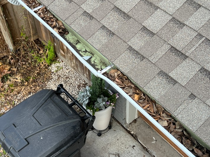 Professional spring gutter inspection identifying winter damage and planning necessary repairs