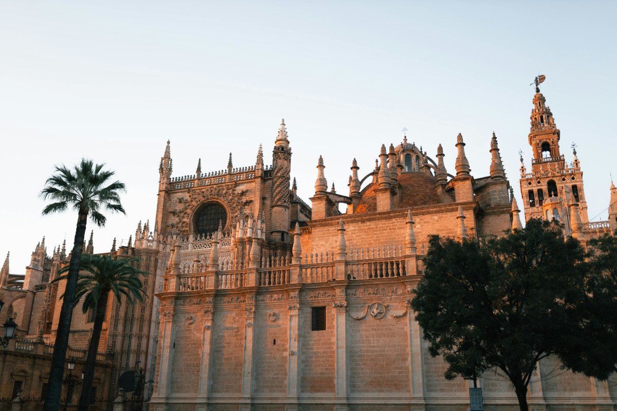 The magnificent Seville Cathedral captured in warm evening light, showcasing its gothic architecture.