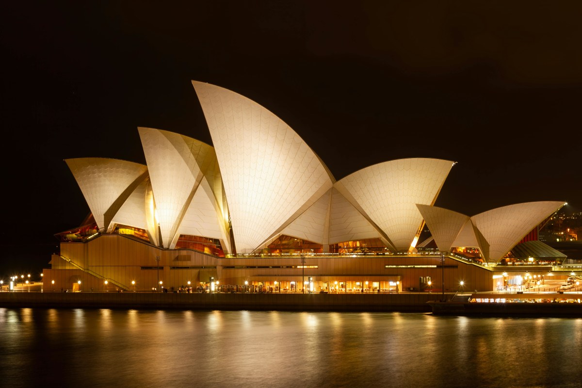 Stunning night view of the Sydney Opera House illuminated, showcasing its unique architecture.