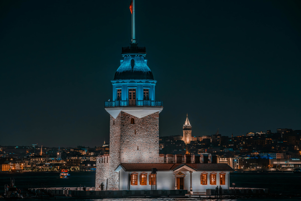 Captured at night, Maiden's Tower stands vibrant against Istanbul's skyline, showcasing its historical allure.