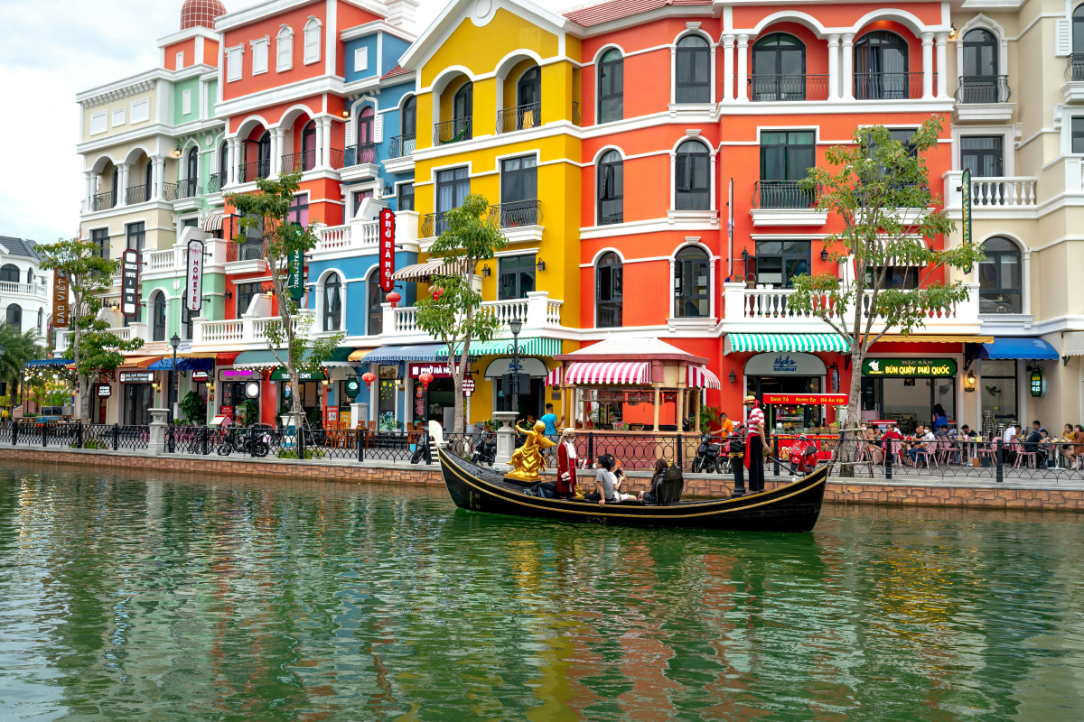 Vibrant canal scene with gondola and colorful buildings at Grand World Phu Quoc.