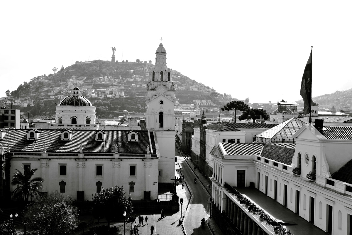 Black and white view of Quito's historic architecture and Panecillo Hill with the Virgin of Quito statue in Ecuador.