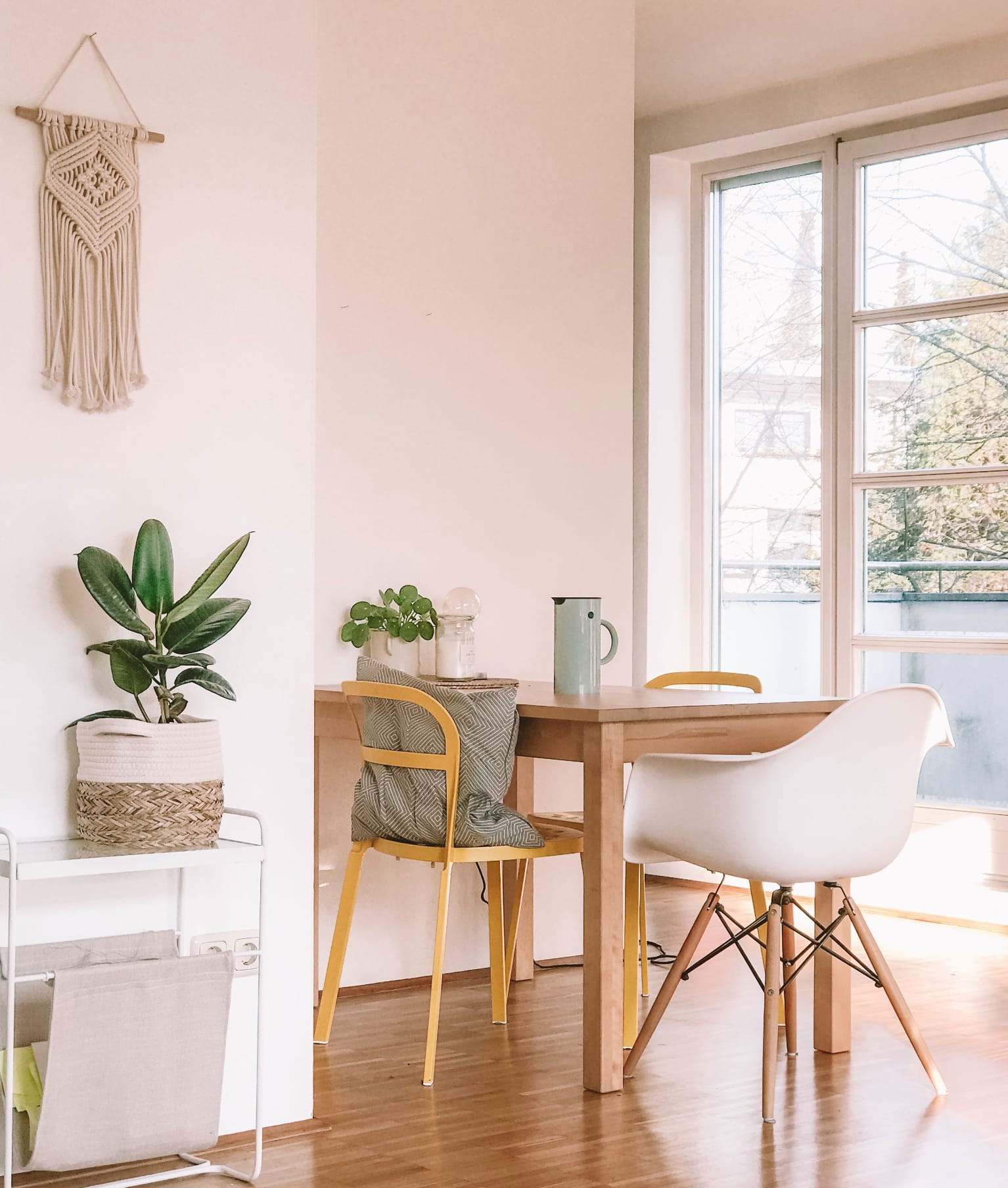 Dining area with macrame wall hanging