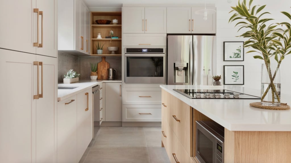 Kitchen with white cabinets, stainless steel appliances, island with integrated ceramic hob
