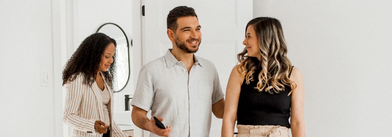 Couple accompanied by their real estate broker during the visit of a property