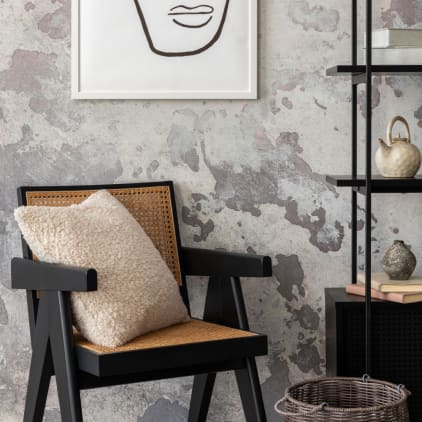 Close-up of chair, artwork and bookshelf