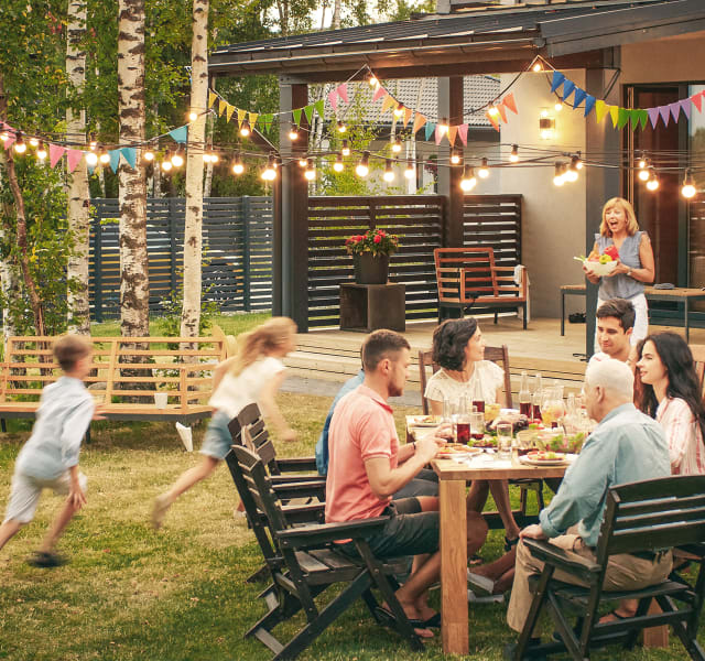 Happy family enjoying a meal in their backyard