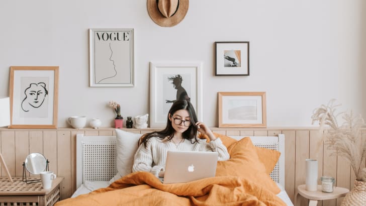 Woman using laptop in bed