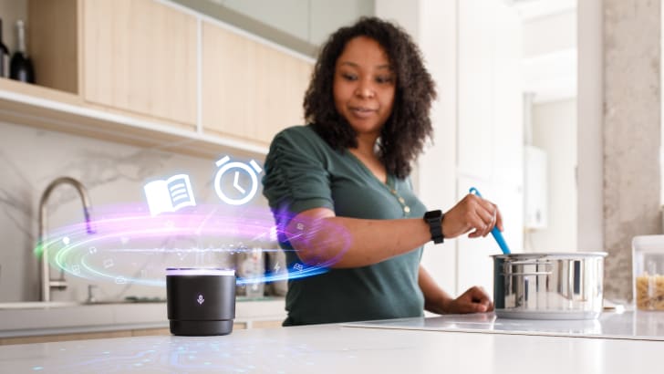 Woman talking to her vocal assistant while cooking in her kitchen