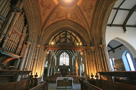 The view of the church interior looking west from under the central tower down into the large nave and aisles.