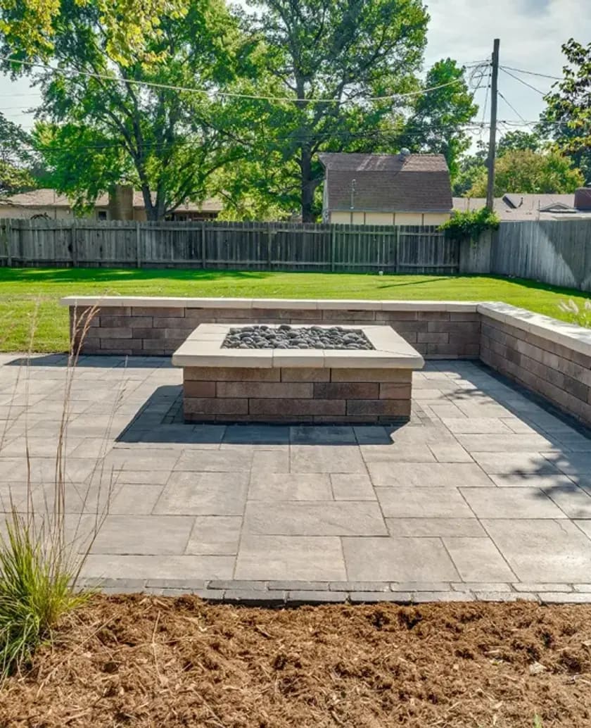 Backyard patio with firepit and retaining wall in Edmonton