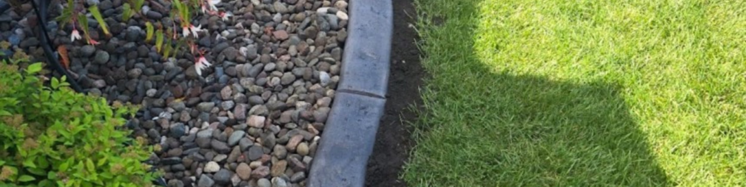 Landscape edging and river rock installation in Edmonton