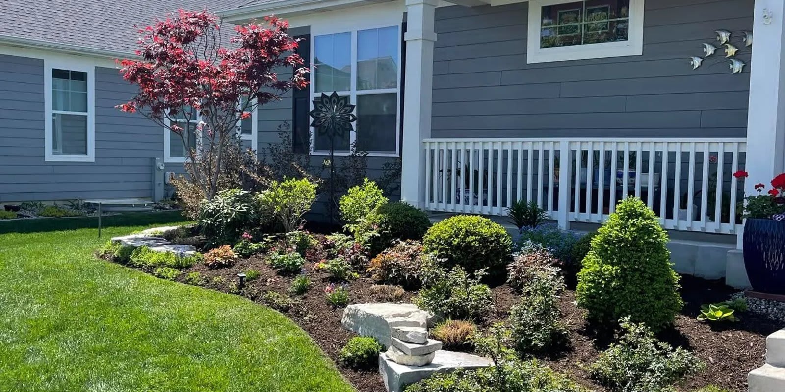 Completed full yard landscaping project in Edmonton featuring sod, paving stone patio, and retaining wall — Serene Landscaping