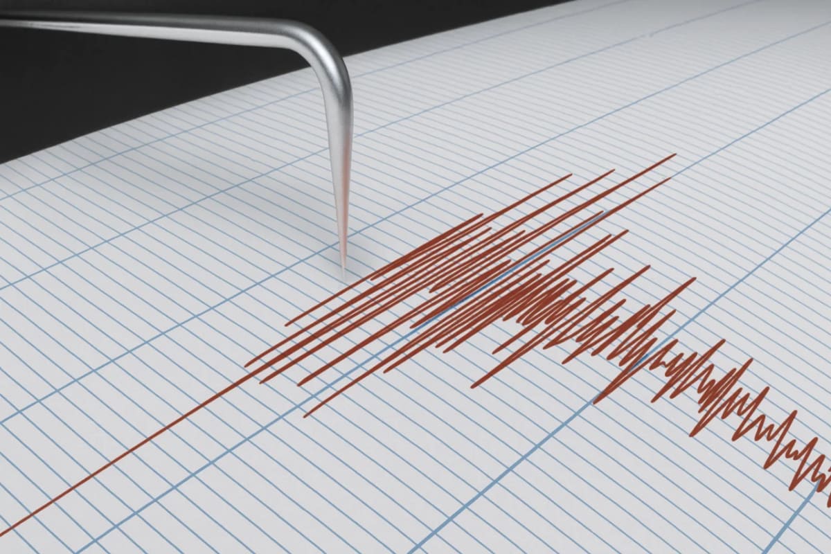 Registro sísmico en un sismógrafo, con la aguja metálica trazando líneas rojas irregulares sobre papel cuadriculado al detectar un movimiento telúrico.